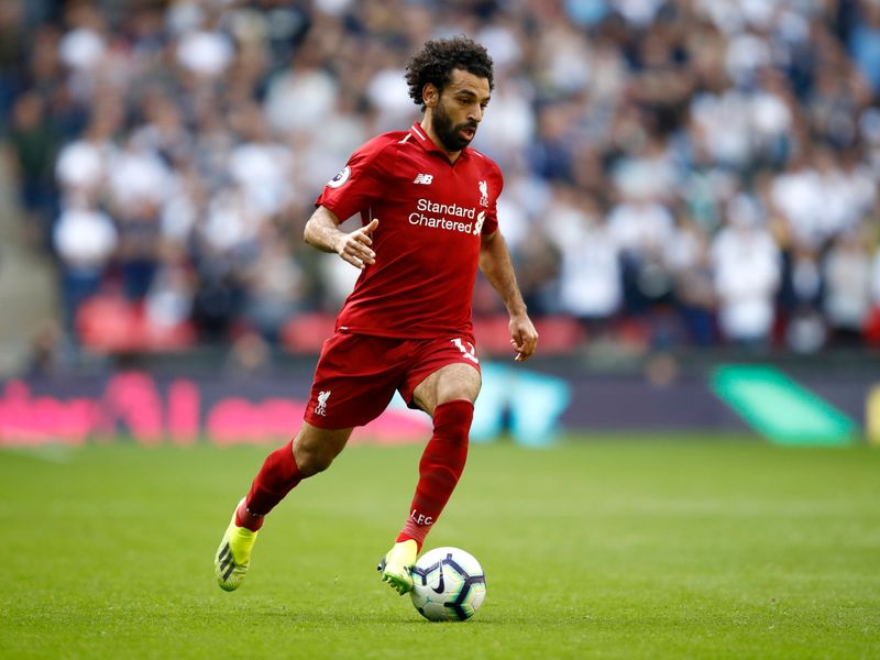 Mohamed Salah in full sprint during a match, showcasing his agility and skill